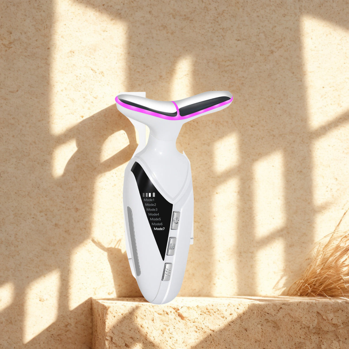 LED Neck Massager on a travertine ledge in warm window light