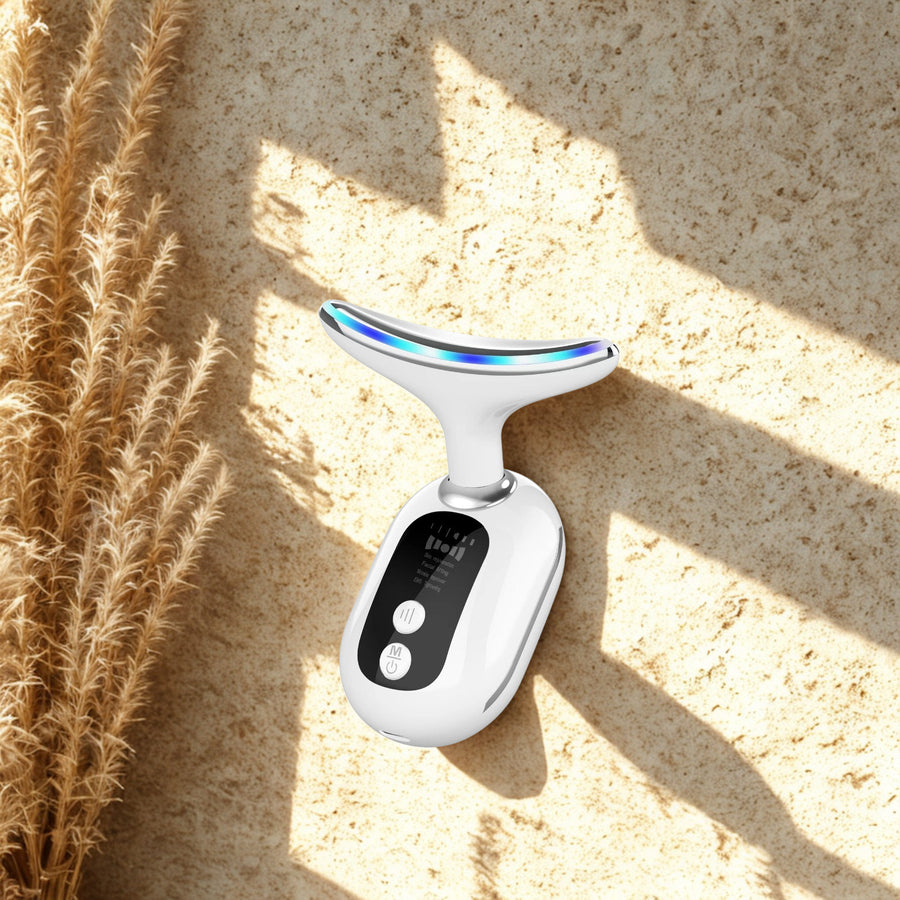Neck Care Beauty Device on warm travertine stone in sunlight