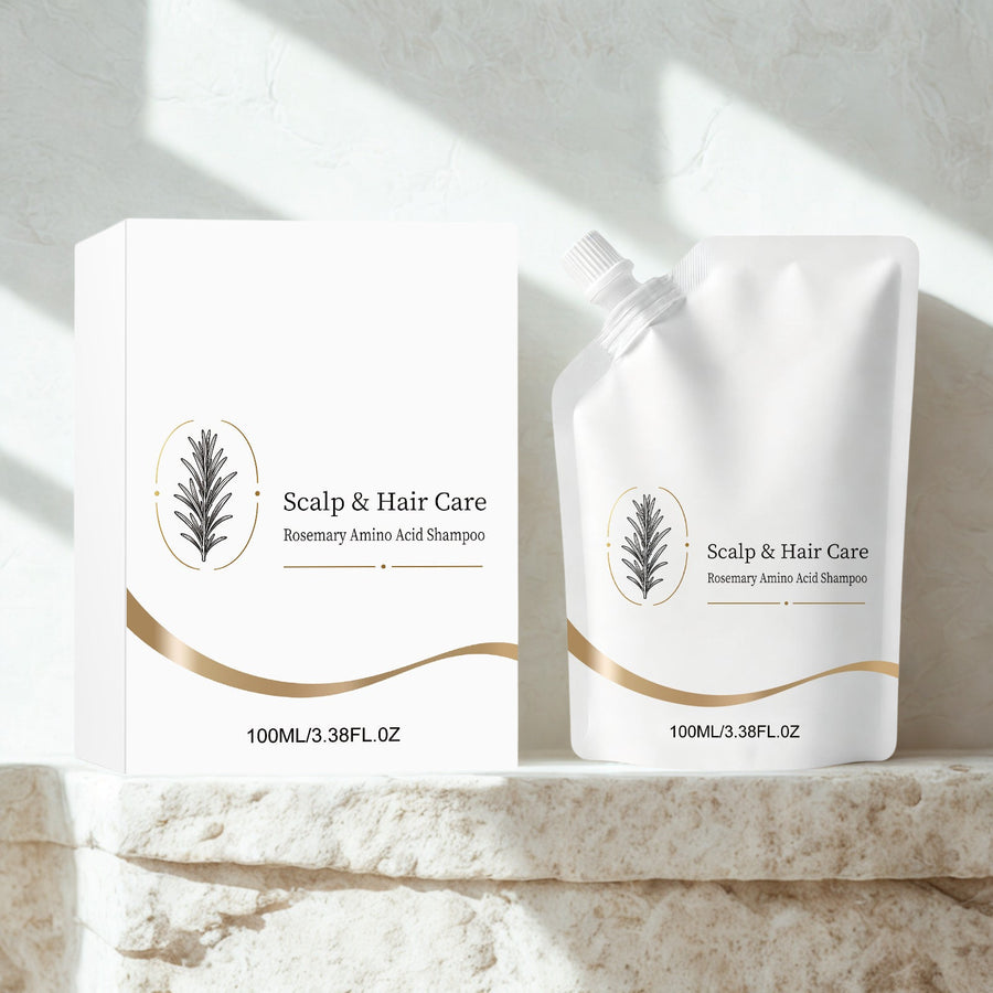Rosemary Shampoo pouch and box on a travertine stone ledge in soft window light
